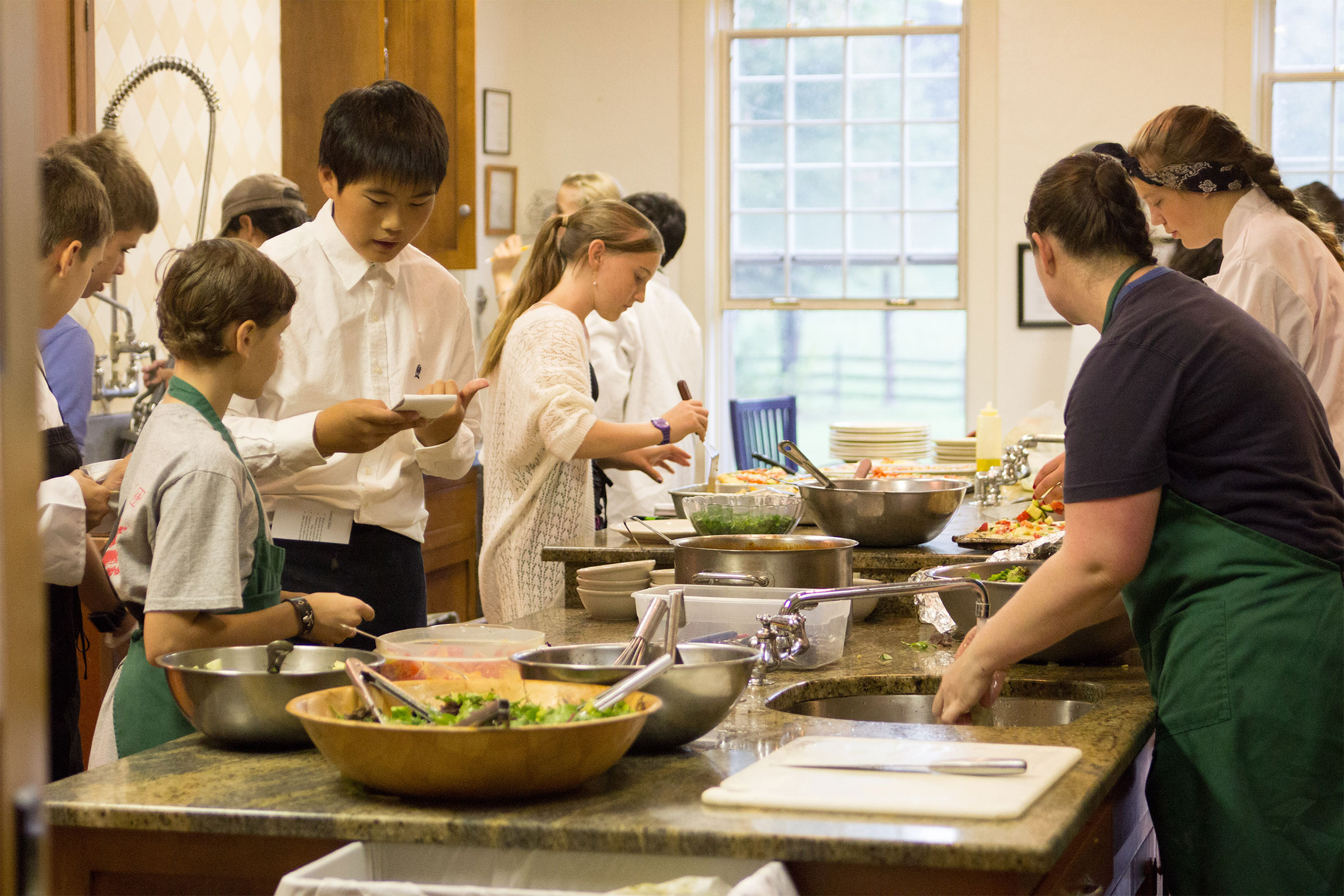 Montessori Adolescent class preparing food in kitchen