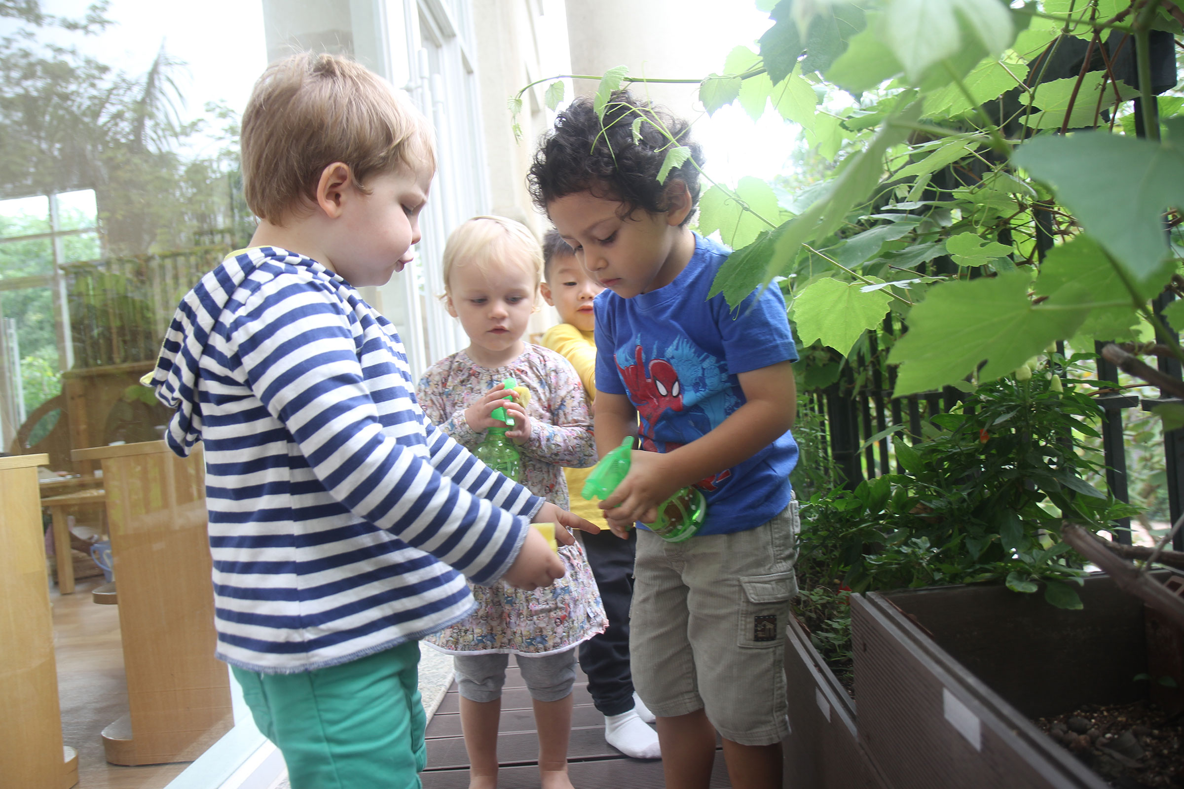 Children from a Montessori classroom outside gardening